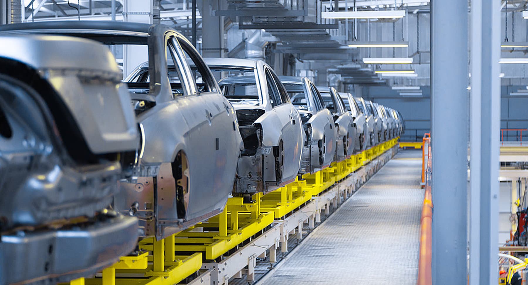 Rohkarosserien von Autos auf einer Fertigungslinie in einer Werkshalle
